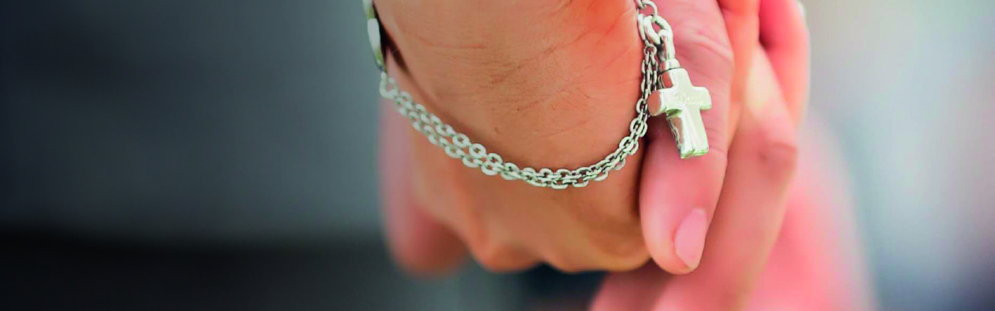 Holding hands wearing jewellery